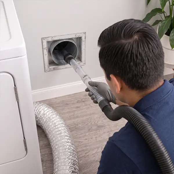 Technician providing complete dryer vent cleaning services in Conroe Texas